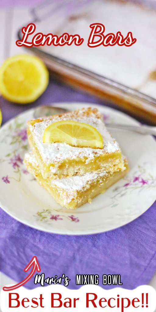 Closeup shot of two lemon bars on plate with baking dish in background