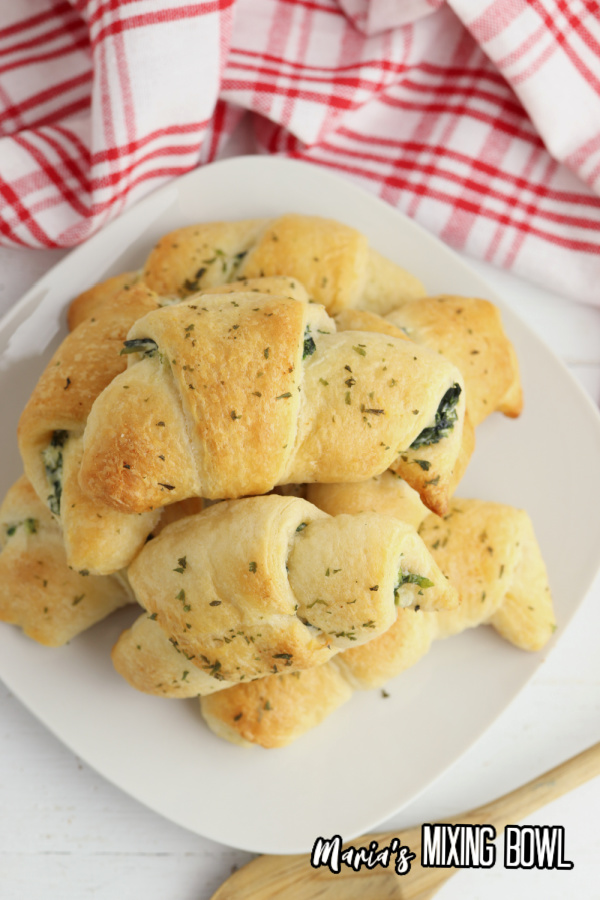 Overhead shot of spinach artichoke crescent rolls on plate