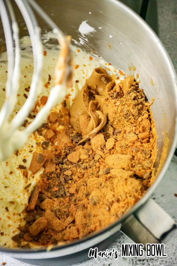 Peanut butter cheesecake mixture ingredients in mixing bowl