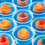 Pool Party Jello Shots on a tray gummy bears and peach gummies