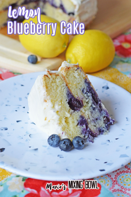 Lemon Blueberry Cake on blue speckled plate lemons and cake in background