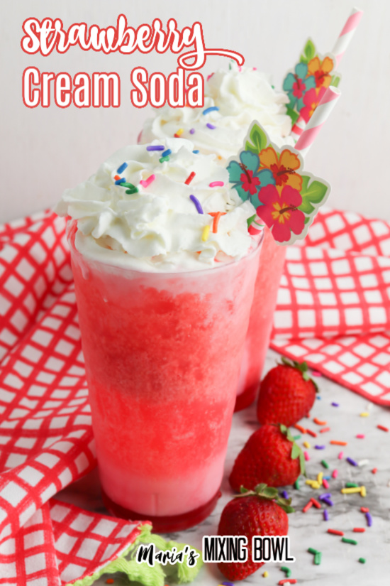 Two strawberry cream sodas topped with whipped cream