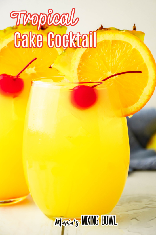 Tropical Cake Cocktail garnished with cherries orange slices and pineapple