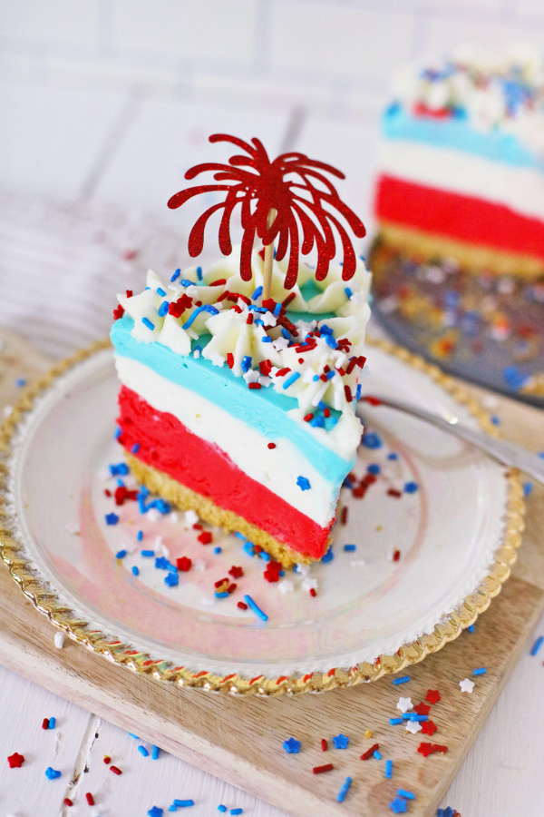 Closeup shot of slice of patriotic Kool Aid cheesecake on plate