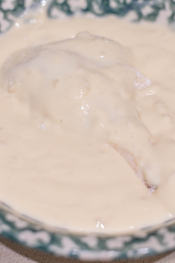 Closeup shot of drumstick in wet batter mixture