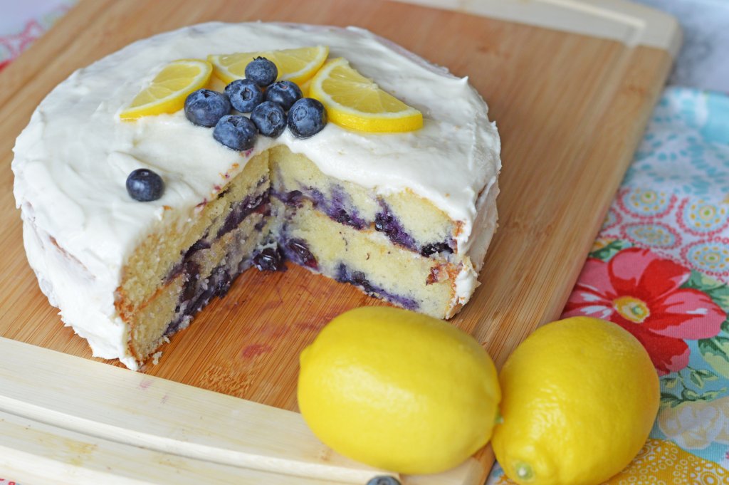 Lemon Blueberry Cake on board with whole lemons