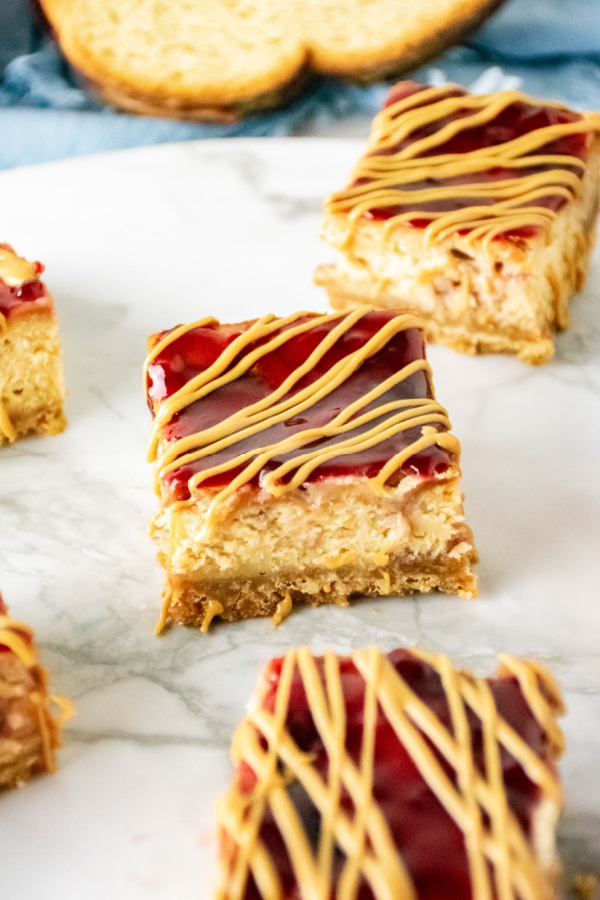 Peanut butter and jelly cheesecake bars on table