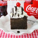 Crock Pot Coca Cola Cake on a white plate cola in background