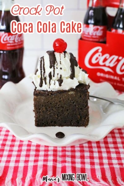 Crock Pot Coca Cola Cake on a white plate cola in background