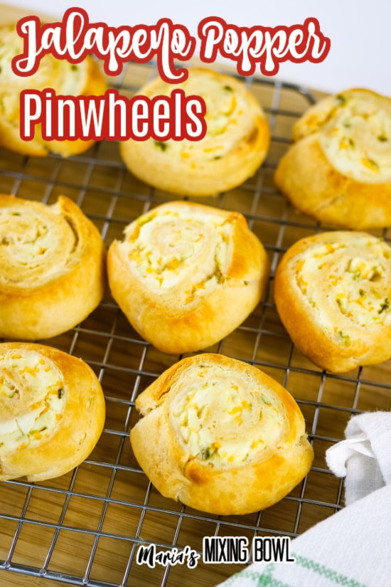 Jalapeno Popper Pinwheels on a cooling rack and board