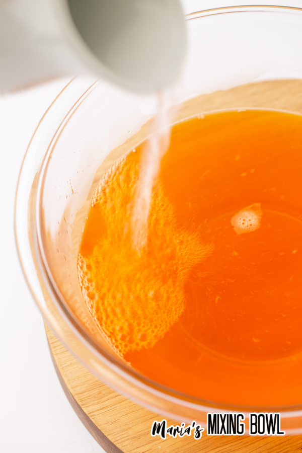 Water being poured into orange Jello
