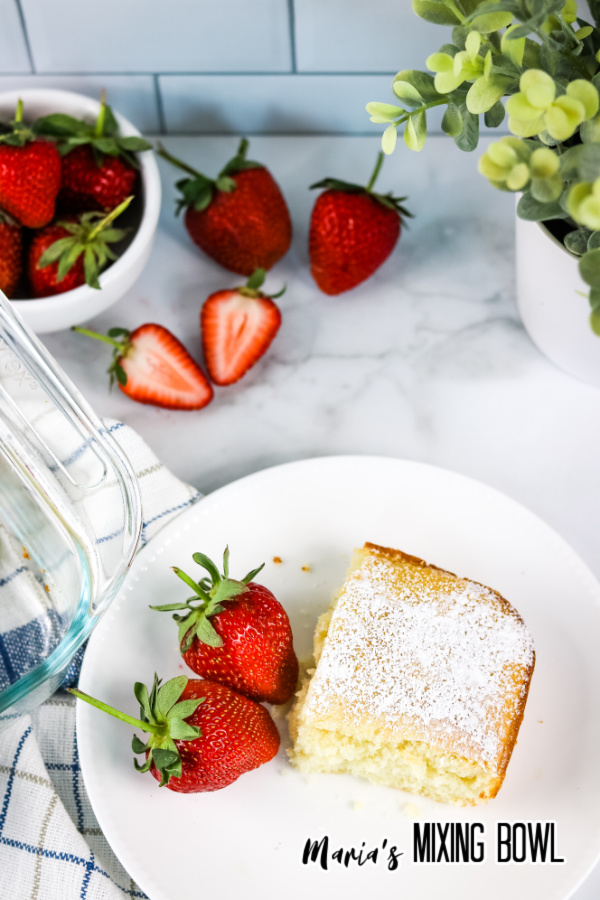 Lazy Cake Recipe on a white plate with strawberries