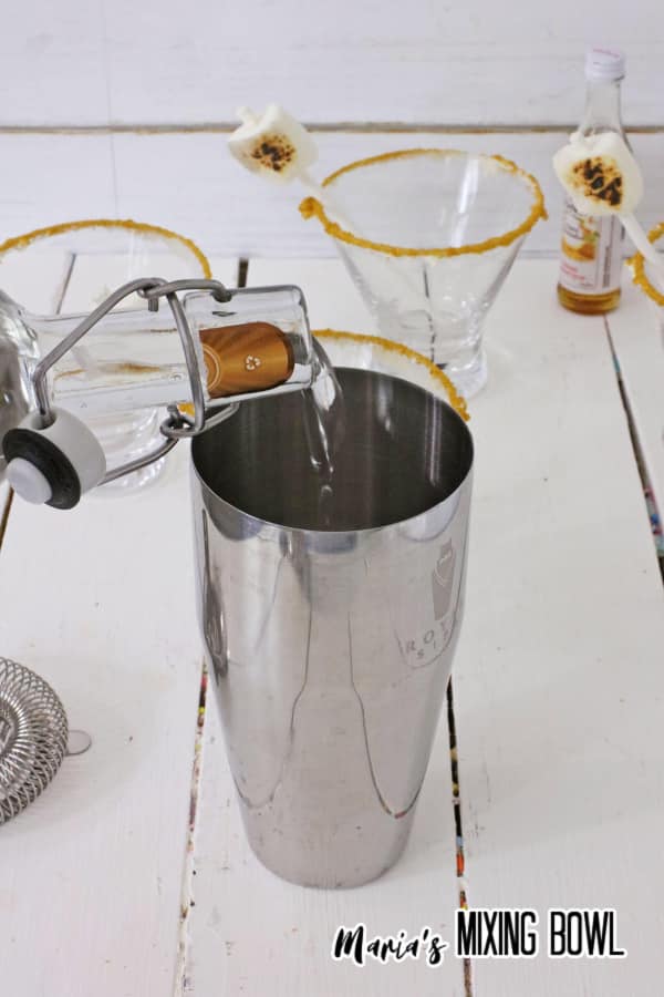 Ingredients being poured into cocktail shaker