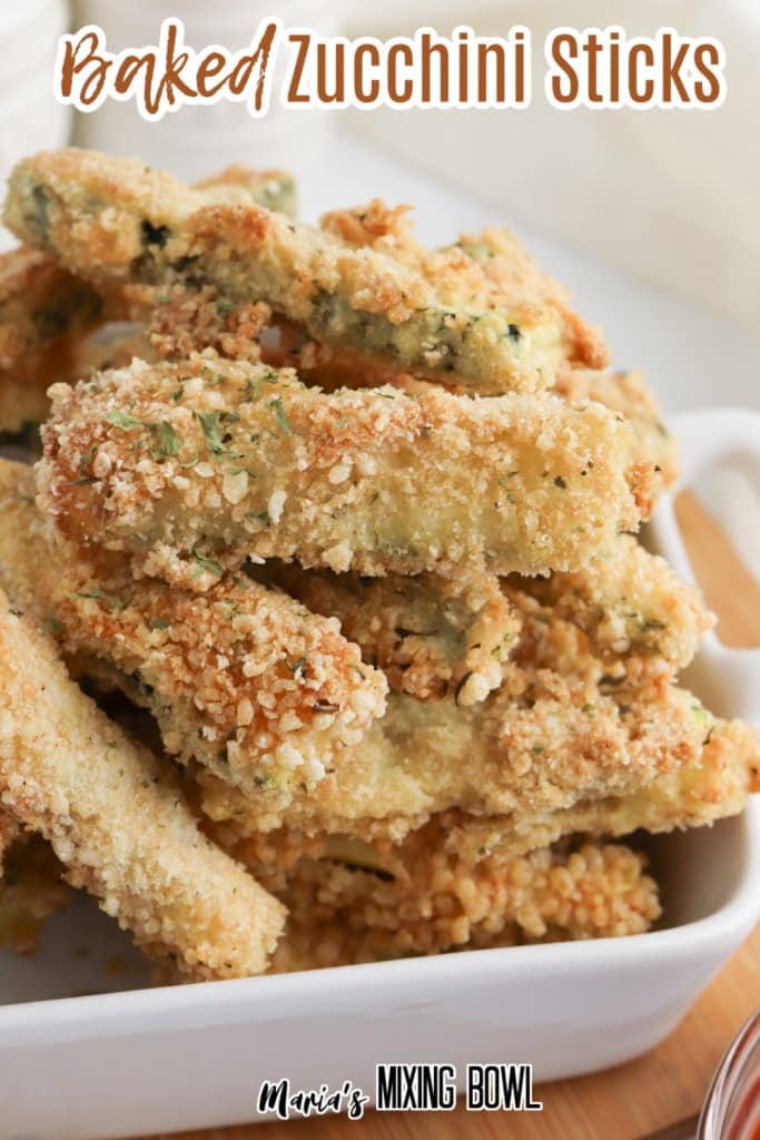 close up baked zucchini sticks in a white bowl