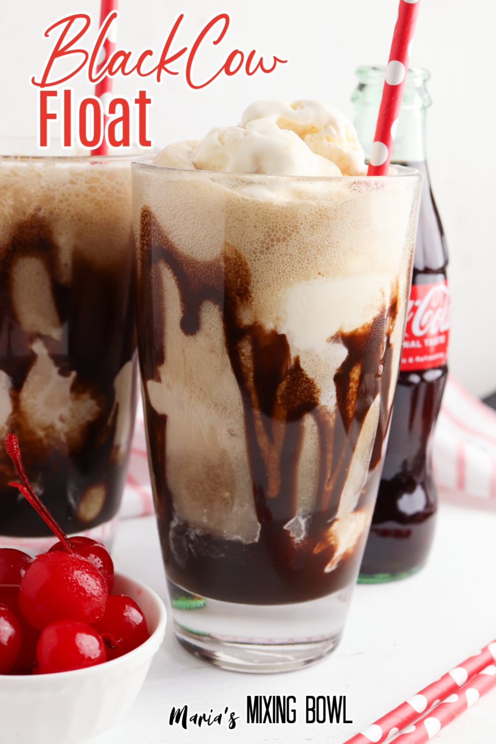 Two glasses of black cow floats with paper straws
