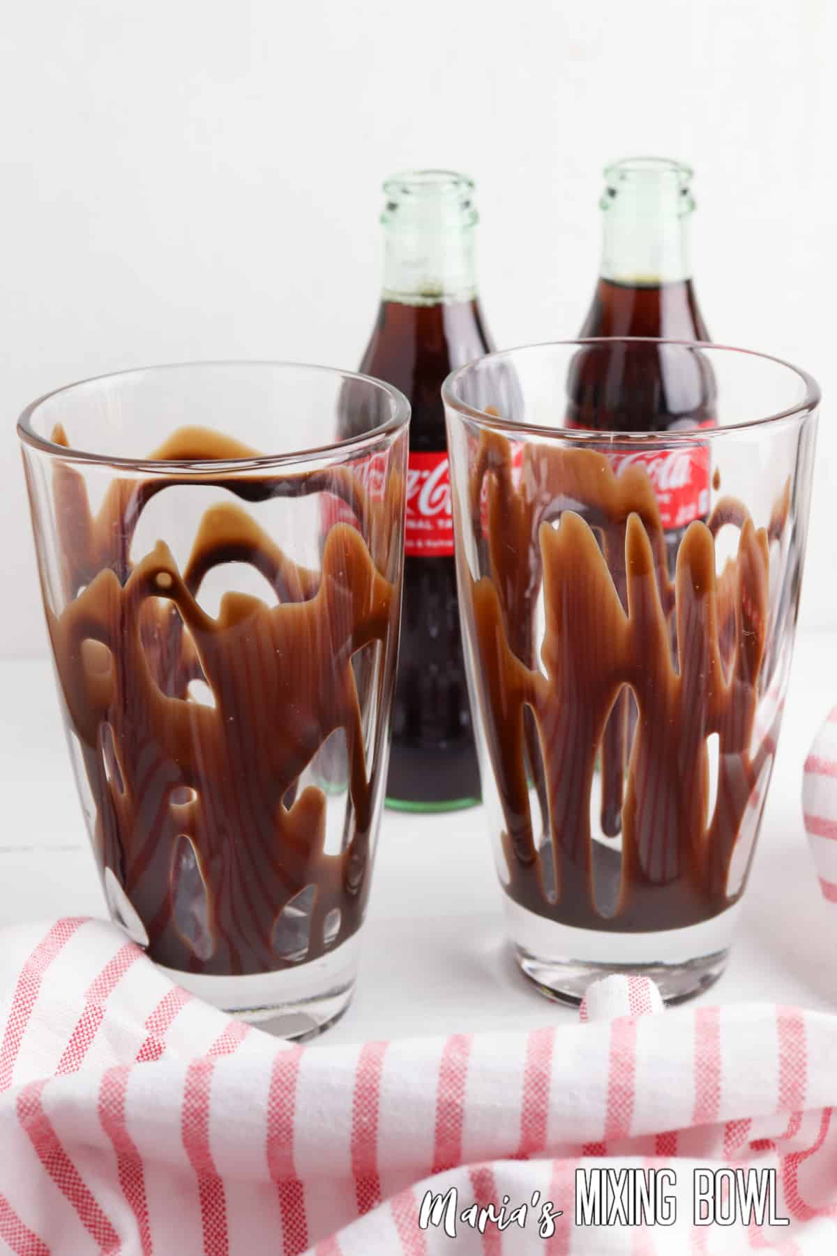 chocolate syrup poured into a tall glass