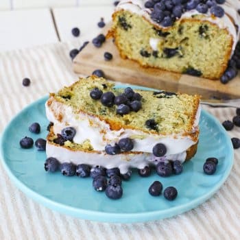 two slices of blueberry banana bread on a blue plate