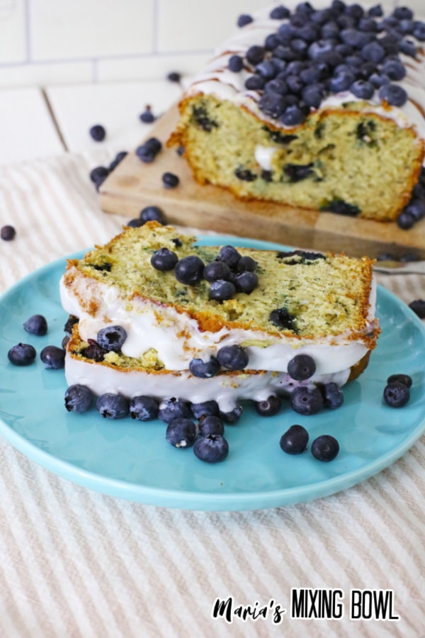close up of a slice of blueberry banana bread on a blue plate