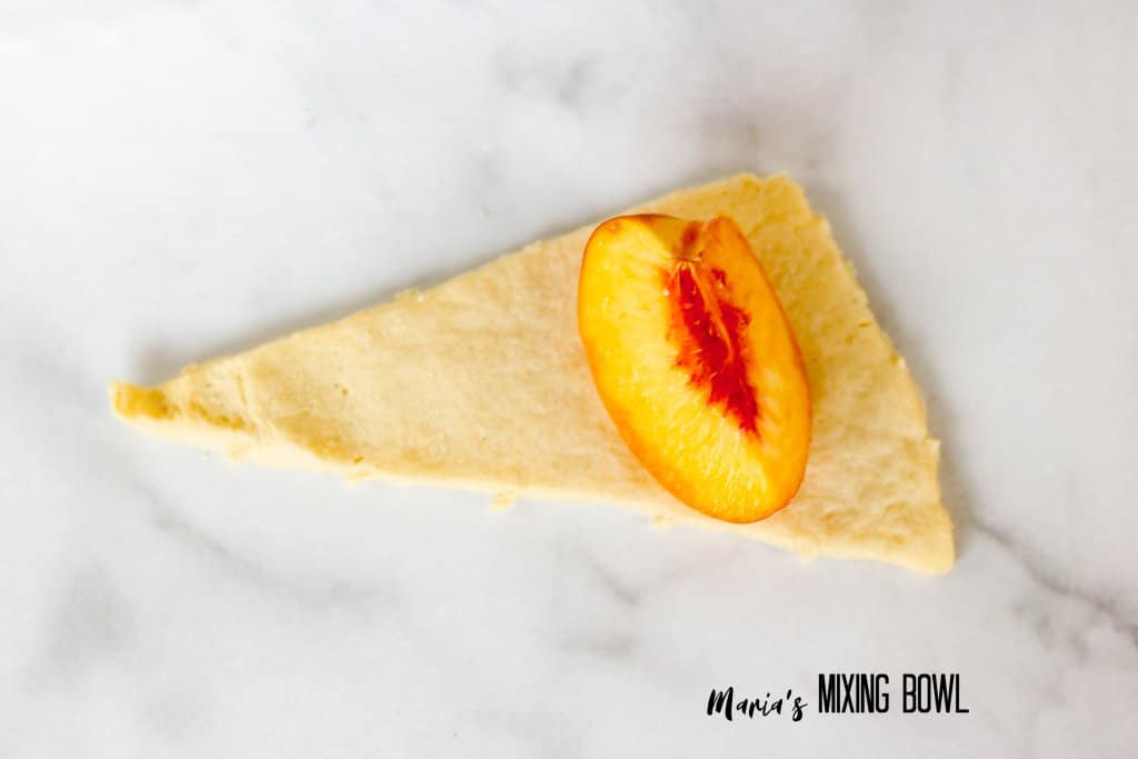 slice of peach on a cresecent roll