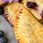close of up blueberry hand pies on a dark gray background