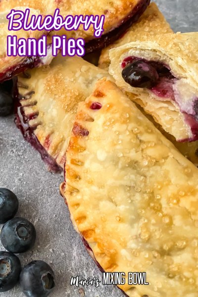 close of up blueberry hand pies on a dark gray background