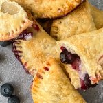 beluberry hand pies stacked on a dark background with the name in blue for pinterst