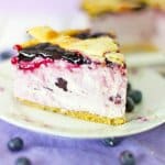 slice of blueberry pie cheesecake on a white plate