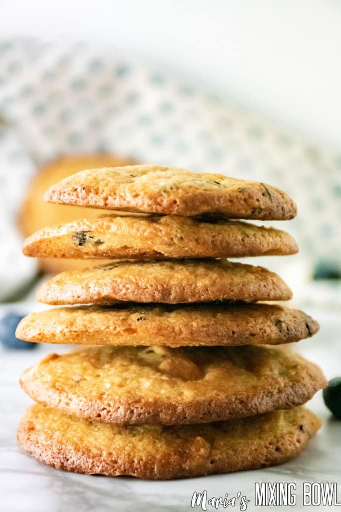 stack of crispy blueberry cookies on a marble counter