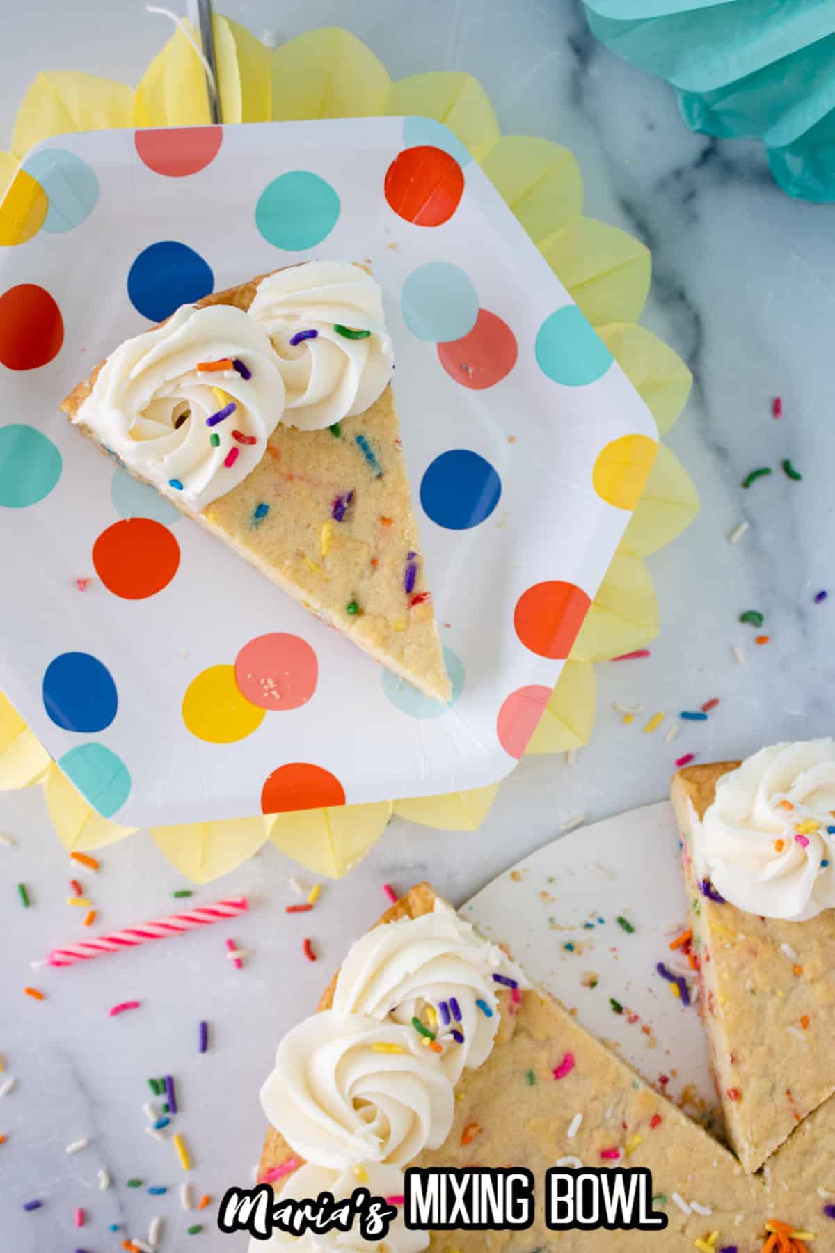 slice of funfetti cookie cake on a birthday plate