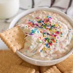 bowl of funfetti dip on a platter with cookies with the name in text