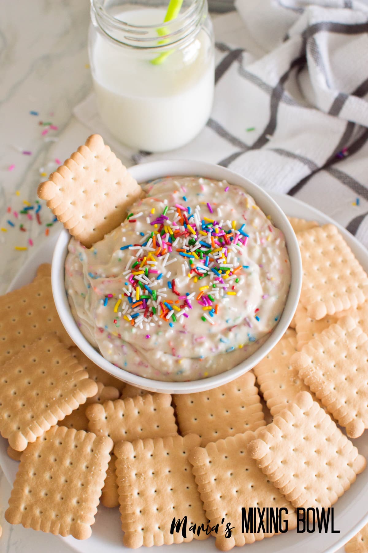 birds eye image of a bowl of funfetti dip with cookies around it