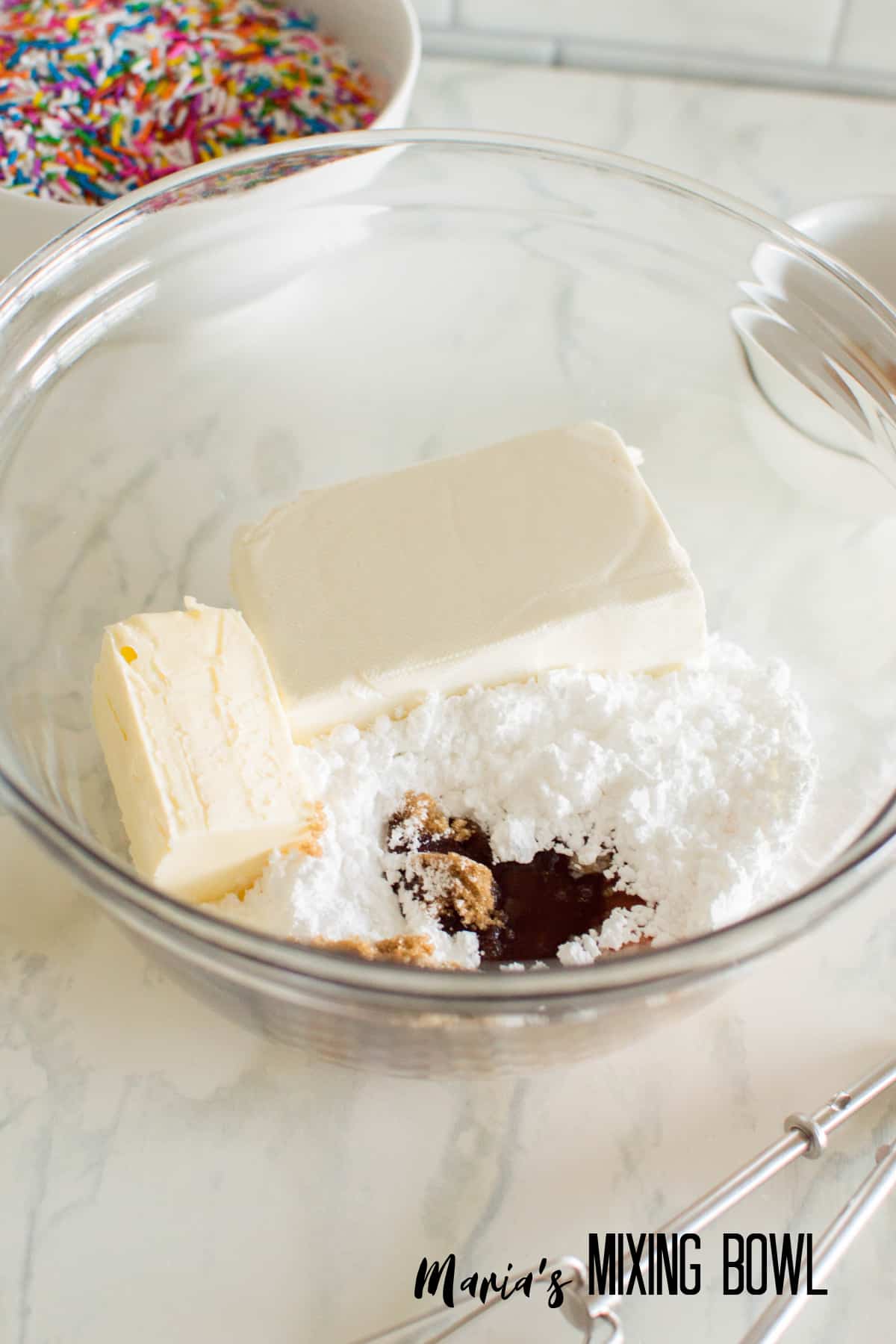 cream cheese, sugar, and vanilla in a glass mixing bowl