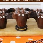 Halloween Pudding Shots with Rumchata on a wooden board with text