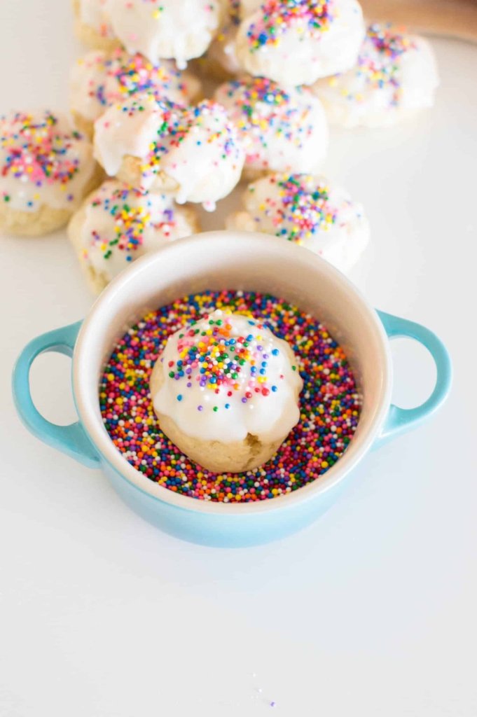 italian sprinkle cookie in a bowl filled with sprinkles