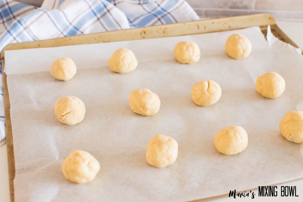 dough balls on a parchment lined baking sheet