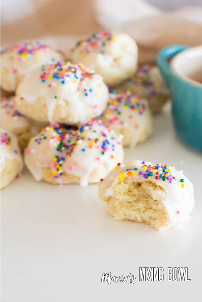close up of the inside of an italian sprinkle cookie on a white table