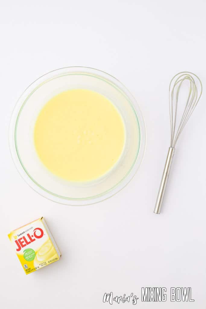 pudding being whisked in a small glass bowl
