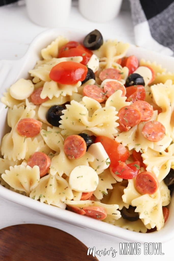 close up of pepperoni pasta salad in a white bowl