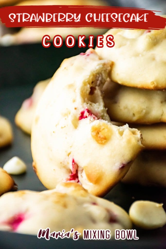 strawberry cheesecake cookie standing up with a bite out of it