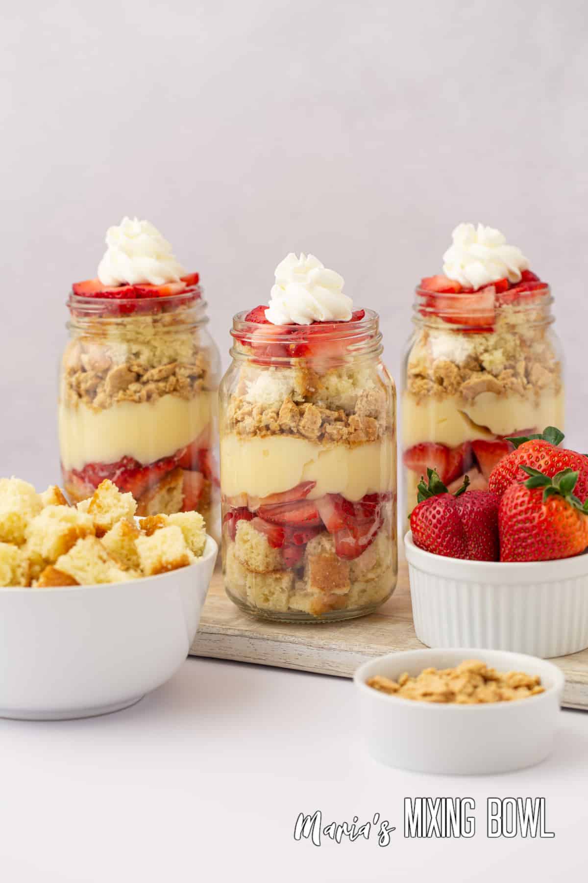 three strawberry cheesecake trifles in jars