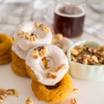 stack of baked pumpkin donuts on a white background with the name in text for pinterest