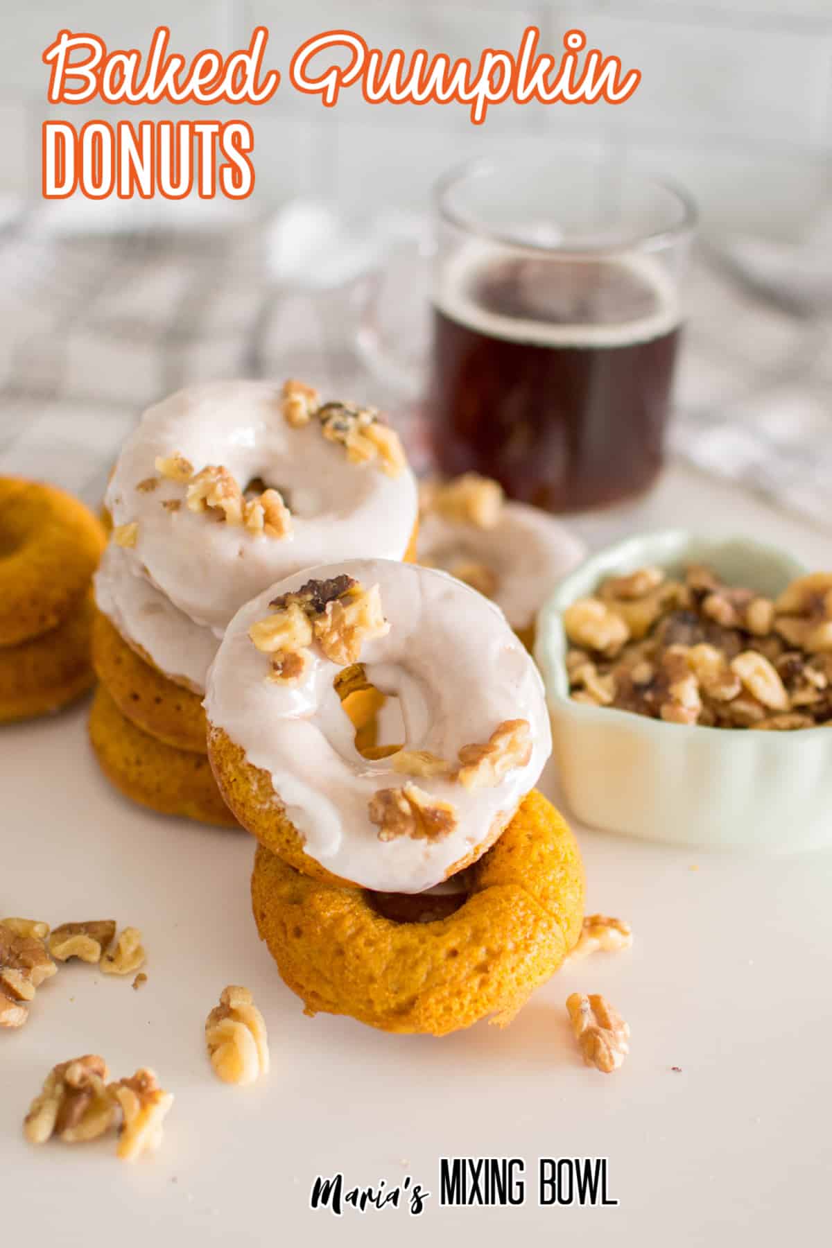 stack of baked pumpkin donuts on a white background with the name in text for pinterest