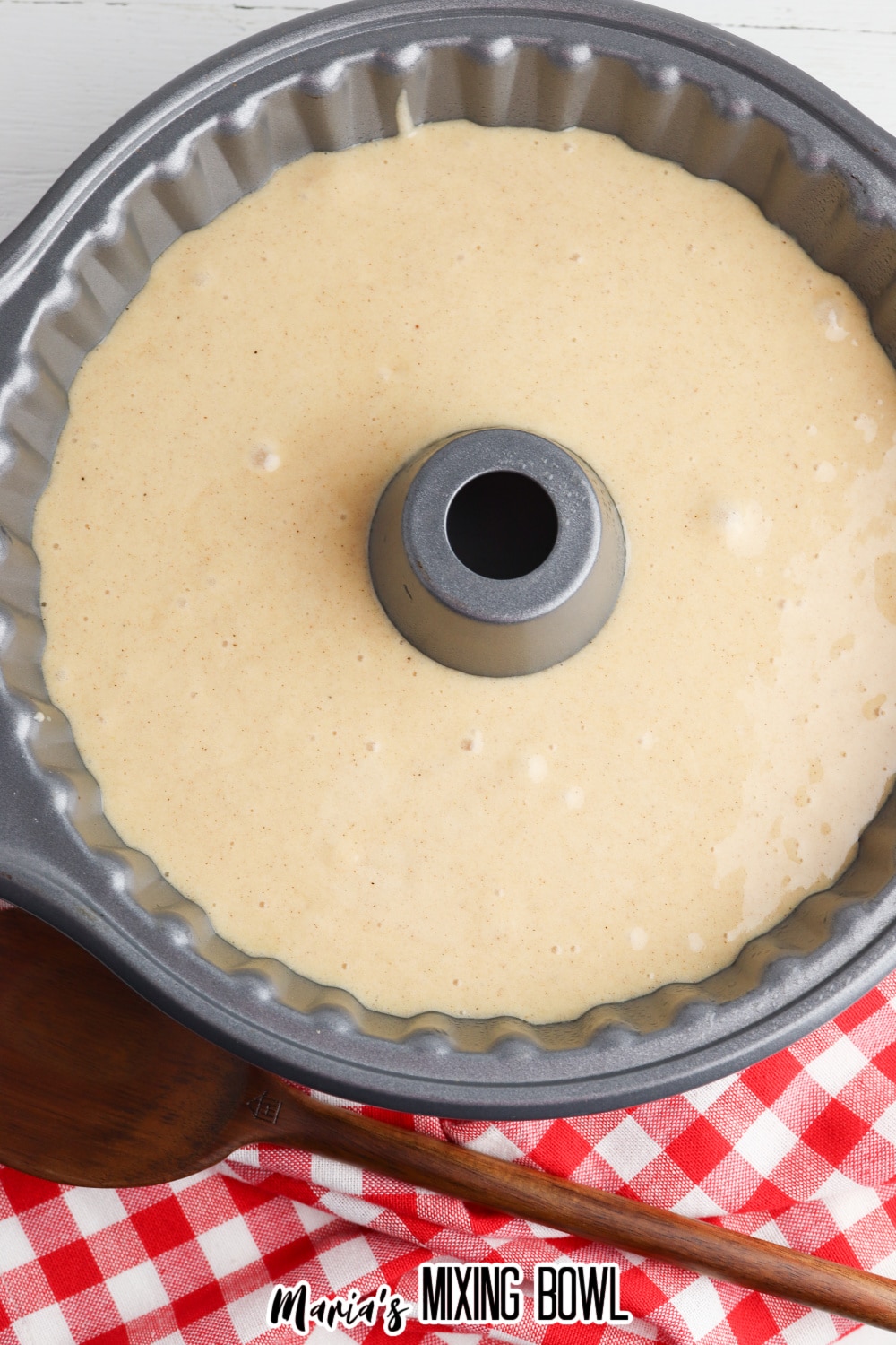 batter into a greased baking pan on a white background