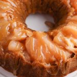 birds eye image of the caramel apple upside down bundt cake on a white cake plate with the name in text