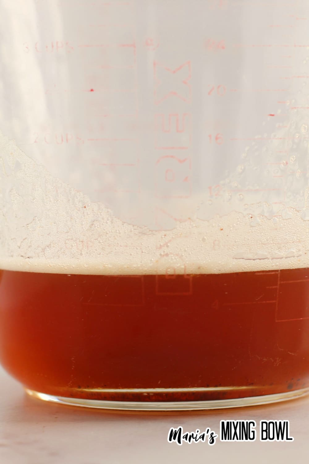 browned butter in a glass mixing cup