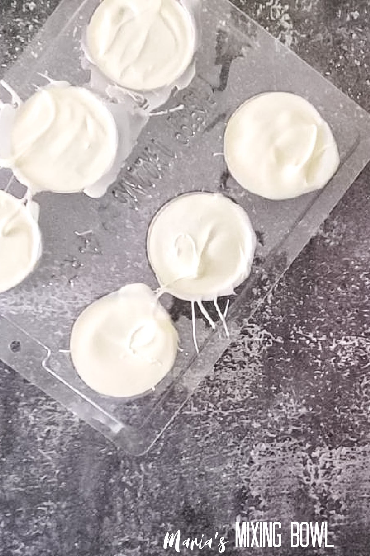 cookie being coated in white candy melts