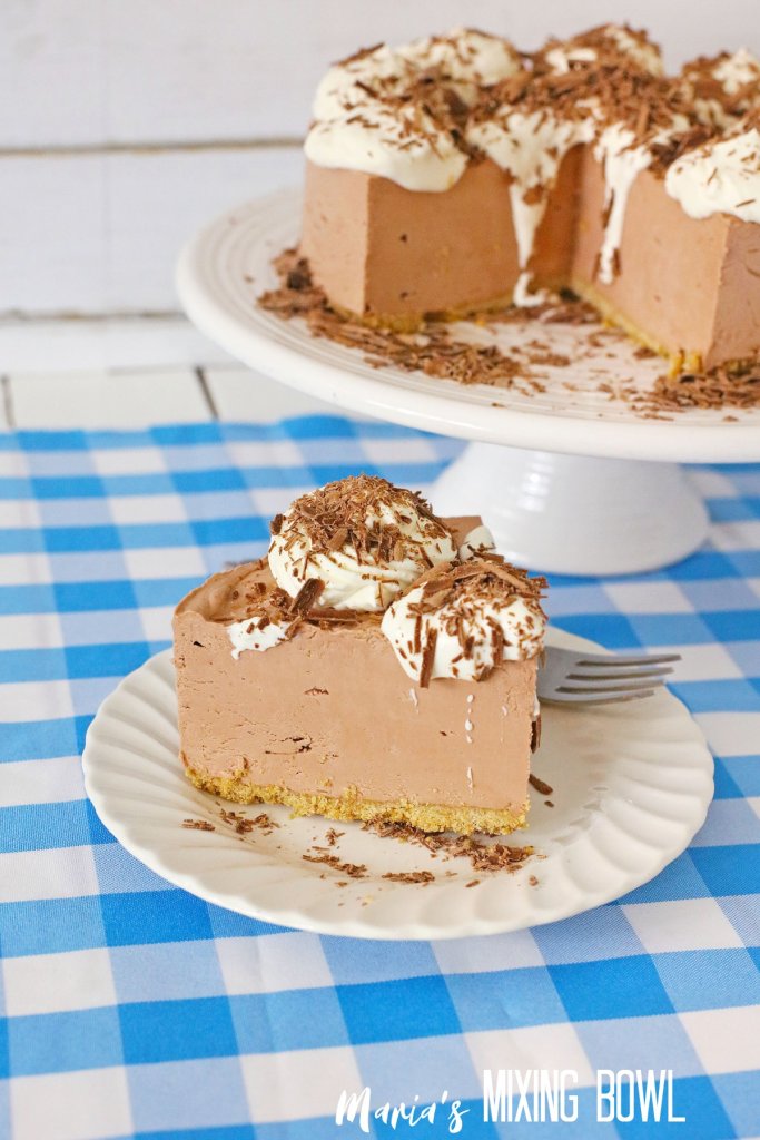 slice of french silk cheesecake on a white plate on a blue and white napkin