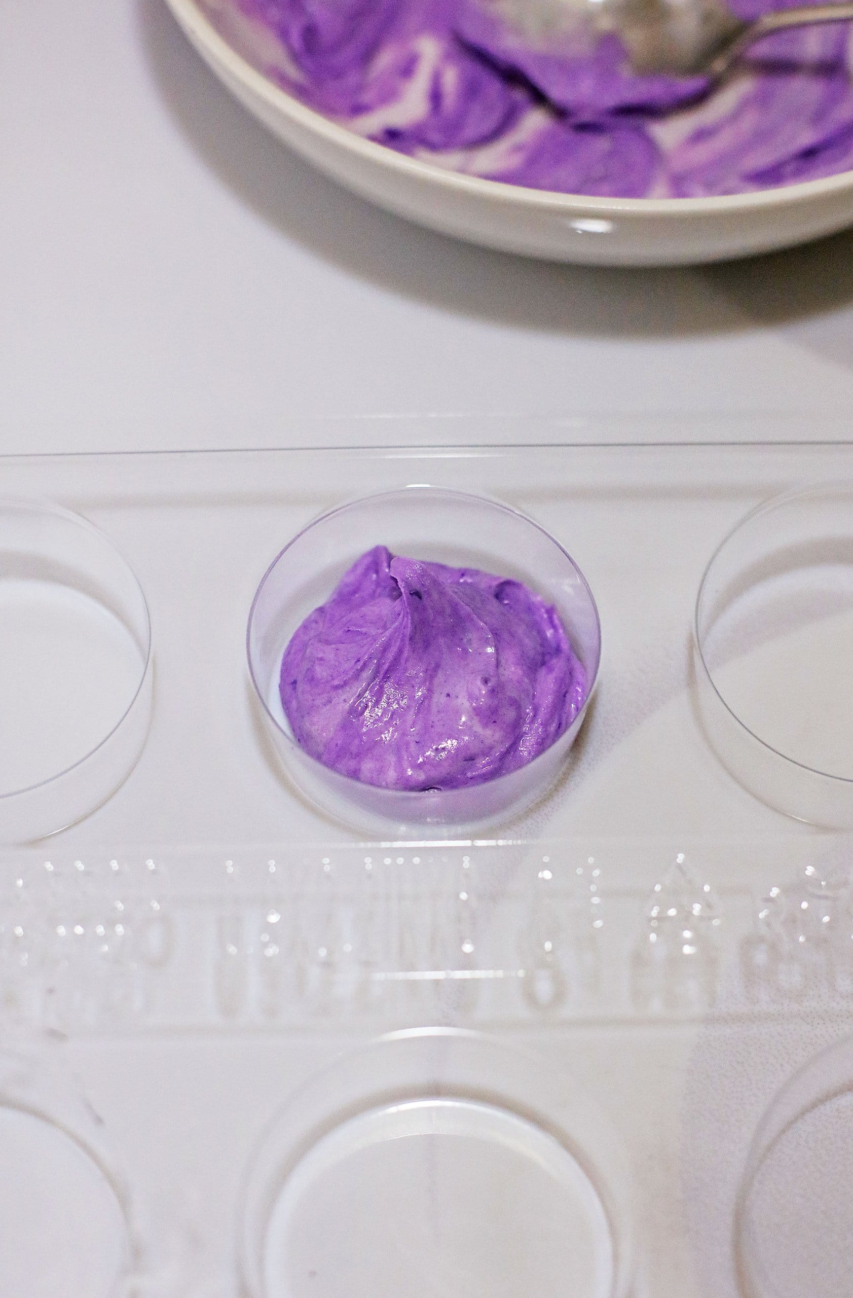 purple almond dark being spread into a cookie mold