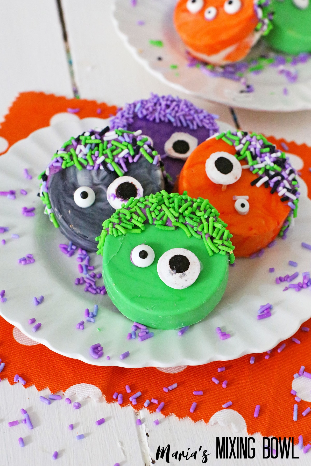colorful monster oreo cookes on a white plate