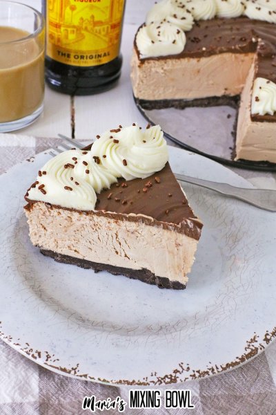 slice of no bake kahlua cheesecake on a white plate with gold rim